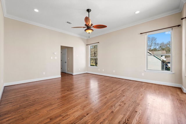 spare room with ceiling fan, crown molding, and dark wood-type flooring