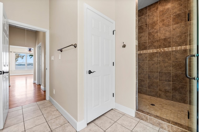 bathroom featuring a shower with door and hardwood / wood-style flooring