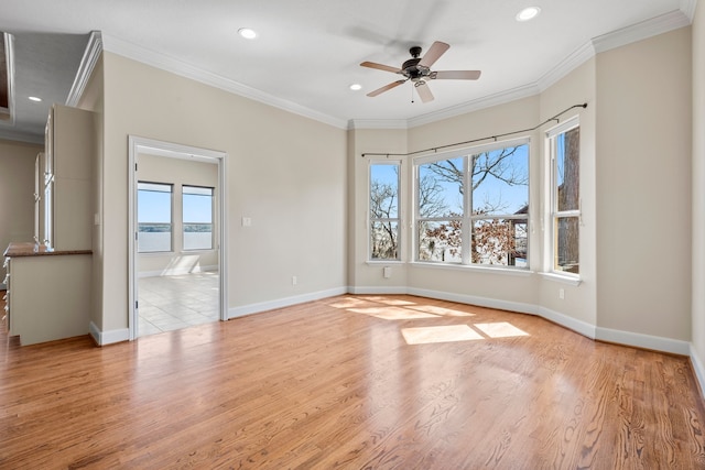 unfurnished room featuring light hardwood / wood-style floors, ceiling fan, and crown molding