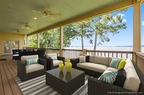 deck featuring ceiling fan and an outdoor living space