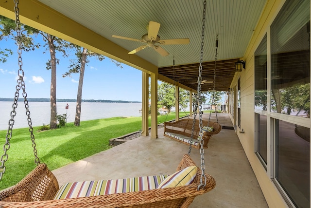 view of patio / terrace with ceiling fan and a water view