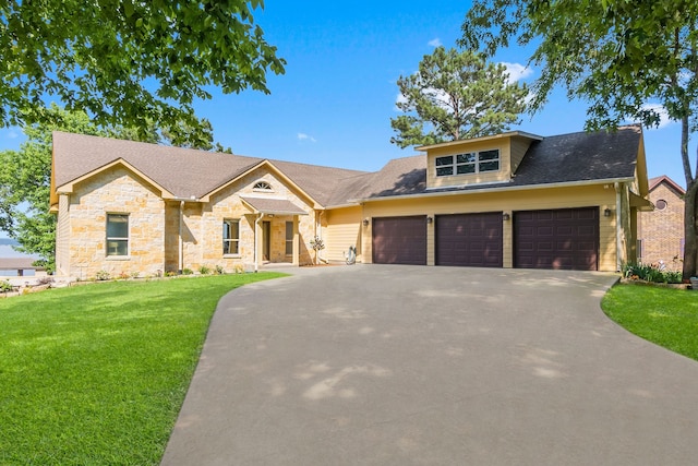 view of front of home with a front yard and a garage