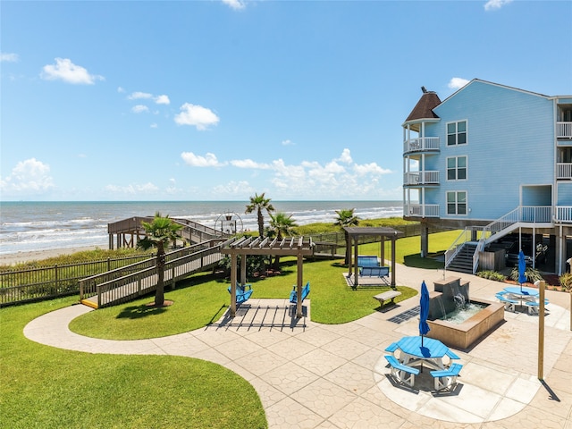 view of patio featuring a water view, a pergola, and a balcony