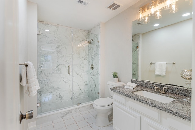 bathroom with a shower with shower door, vanity, tile patterned flooring, and toilet