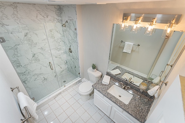 bathroom featuring tile patterned flooring, toilet, vanity, and an enclosed shower