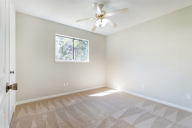 spare room featuring carpet and ceiling fan