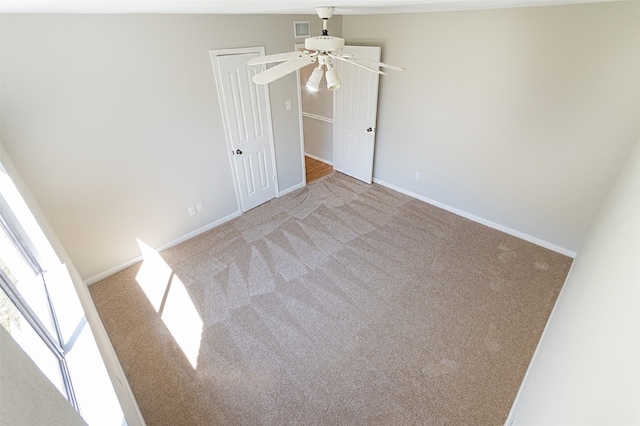 carpeted empty room with lofted ceiling and ceiling fan