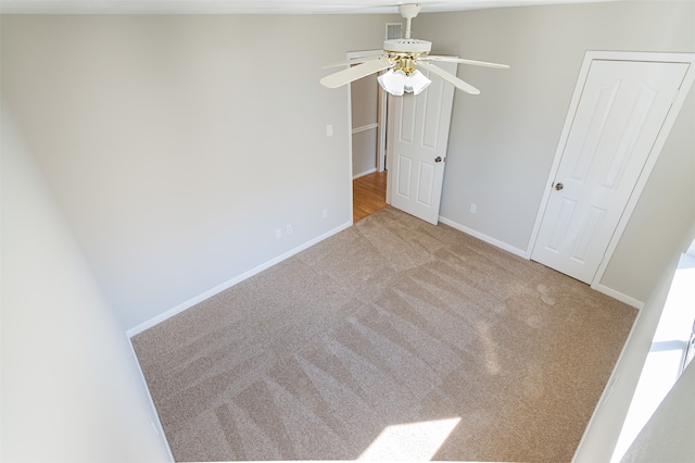 unfurnished bedroom featuring carpet floors and ceiling fan