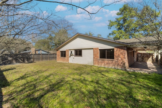 back of house featuring a yard and a patio area