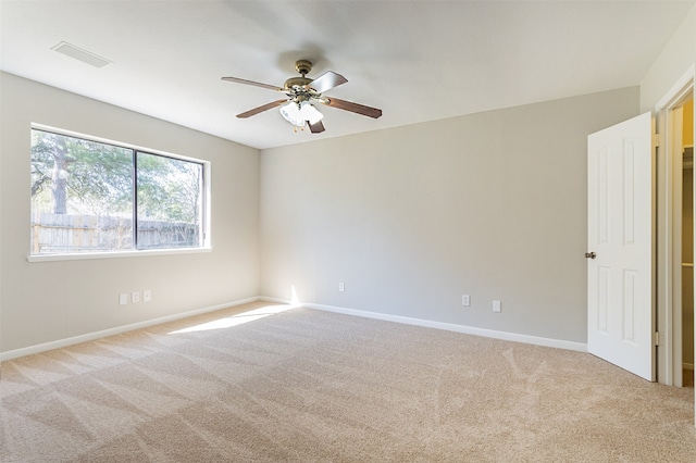 spare room with carpet and ceiling fan