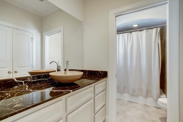 full bathroom with shower / tub combo, toilet, tile flooring, and vanity