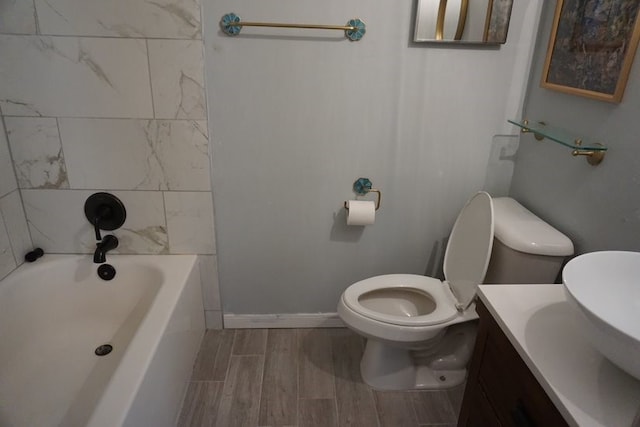 bathroom featuring hardwood / wood-style floors, toilet, and vanity with extensive cabinet space