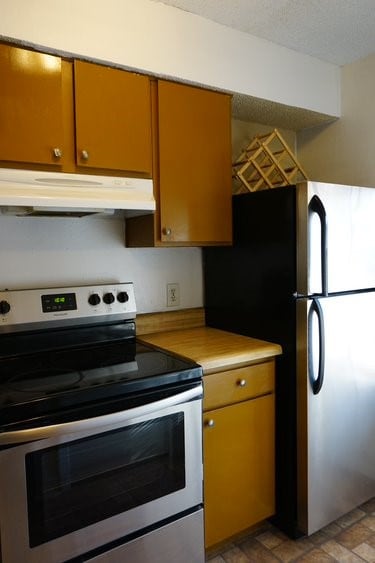 kitchen with stainless steel appliances and light tile flooring