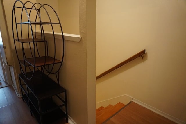 stairway featuring dark wood-type flooring