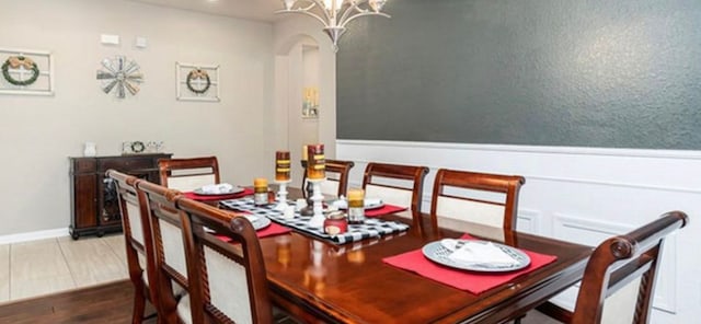 dining room with an inviting chandelier and hardwood / wood-style floors