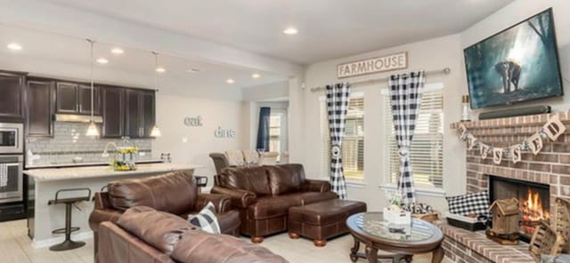 living room with a brick fireplace