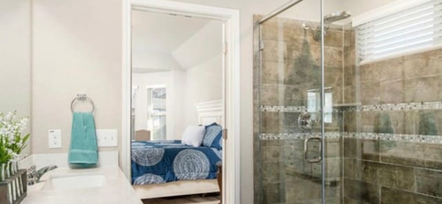 bathroom with an enclosed shower and sink