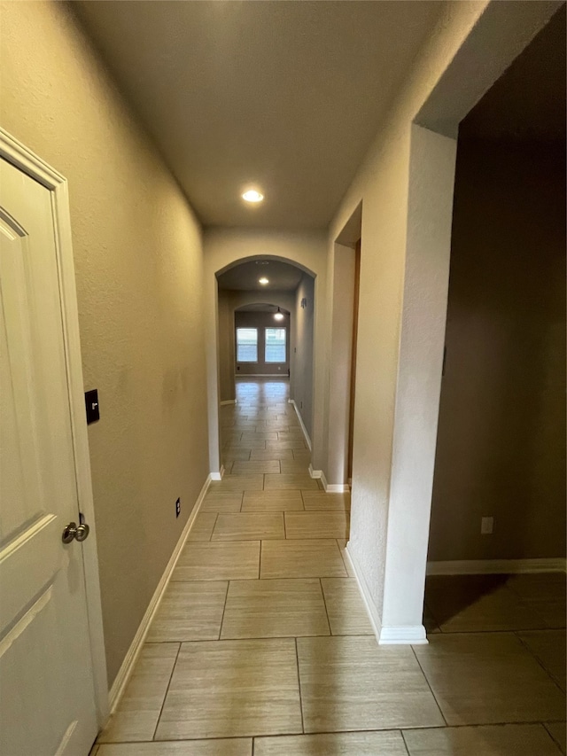 hall featuring light tile flooring