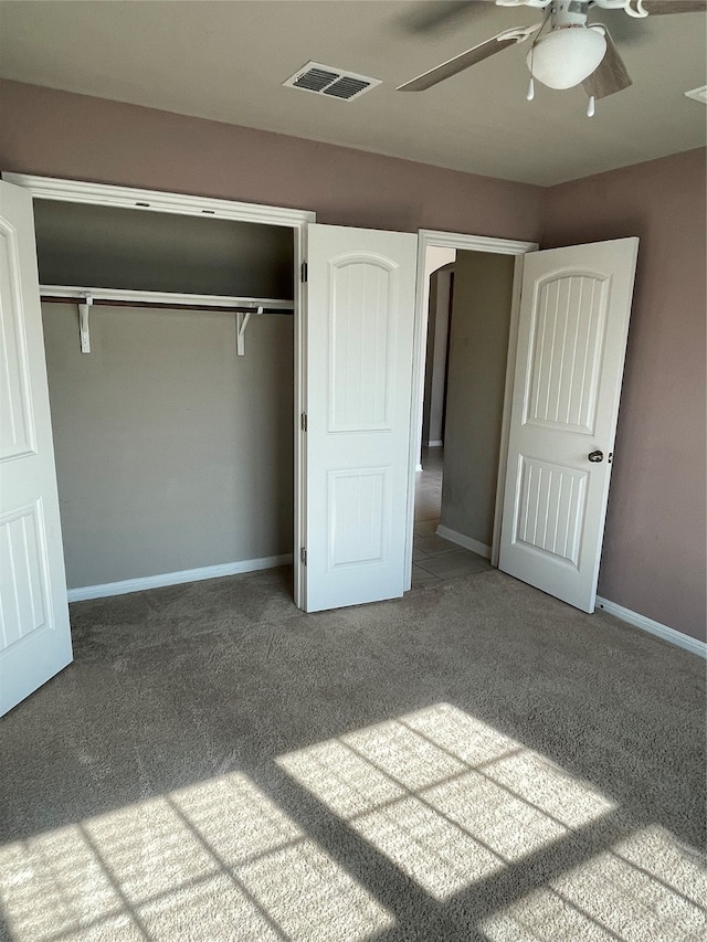 unfurnished bedroom with ceiling fan, a closet, and carpet floors