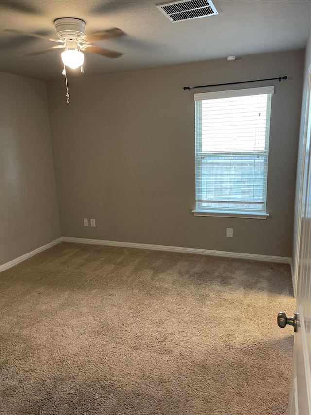 spare room featuring ceiling fan and carpet floors