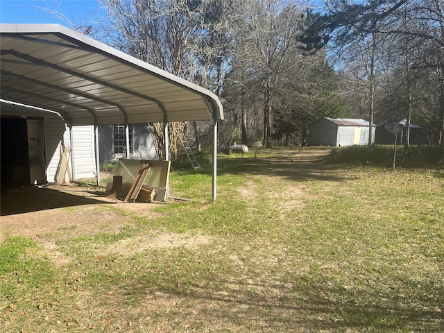 view of yard with a carport and a storage shed