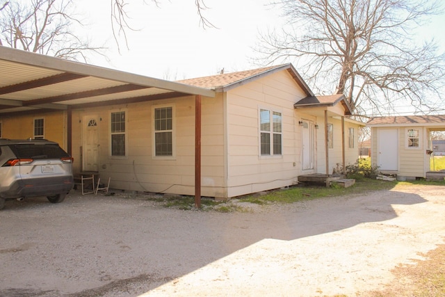 view of side of property with a carport