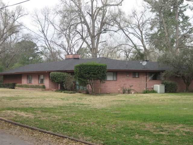 rear view of property with a lawn