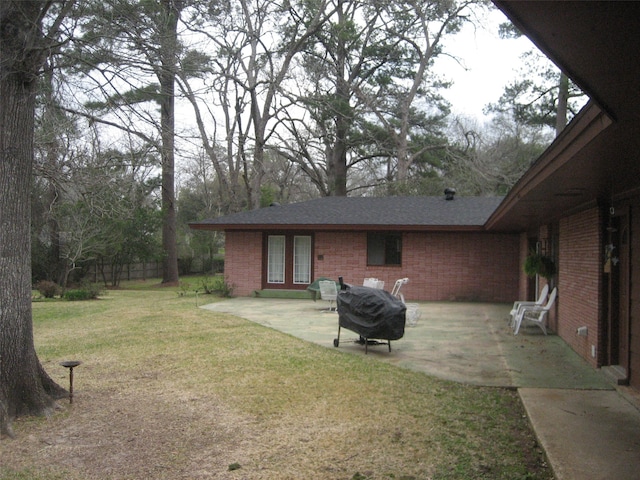 rear view of house with a patio area and a yard