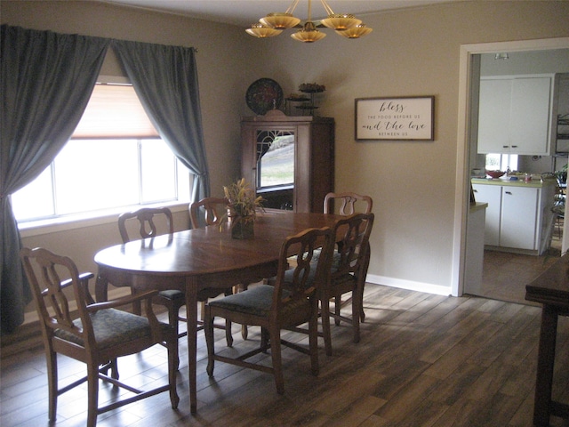 dining space featuring a notable chandelier and dark wood-type flooring