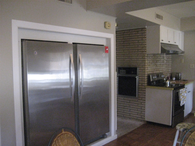 kitchen with backsplash, stainless steel appliances, and white cabinetry