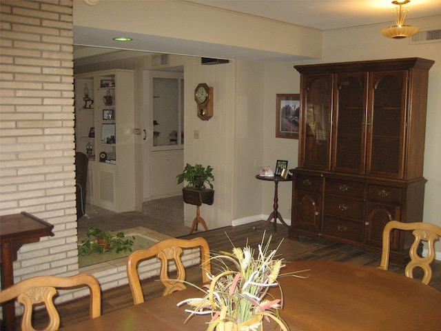 dining space featuring brick wall