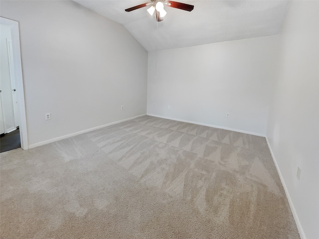 empty room with light carpet, ceiling fan, and lofted ceiling