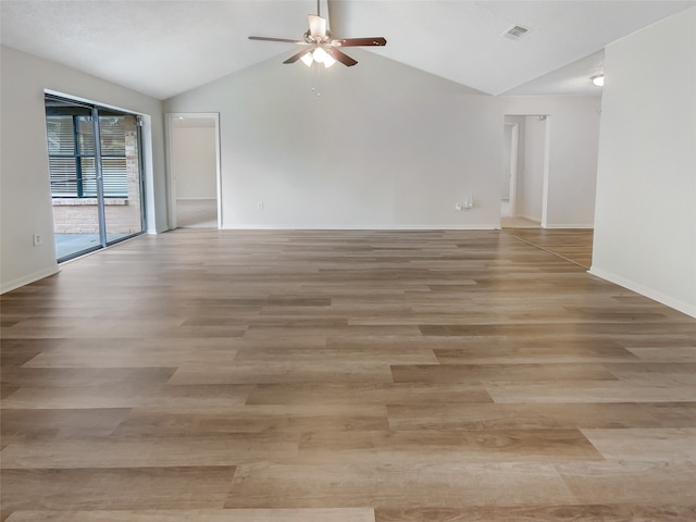 empty room featuring ceiling fan, light hardwood / wood-style flooring, and vaulted ceiling