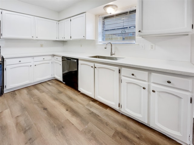 kitchen with white cabinets, dishwasher, and sink