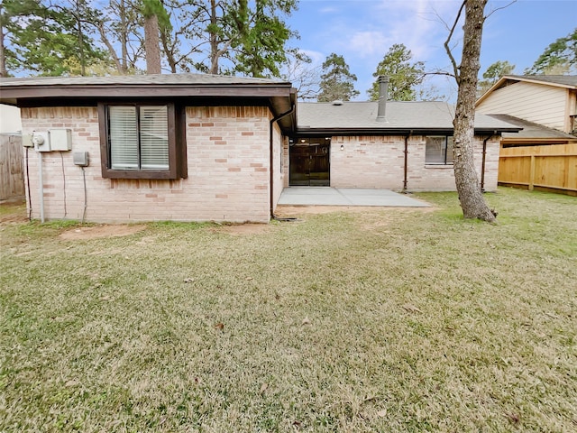 back of house featuring a yard and a patio area