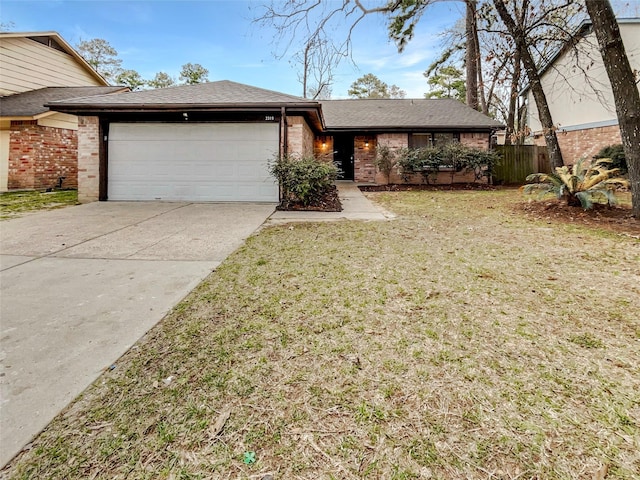 view of front of property featuring a garage and a front lawn