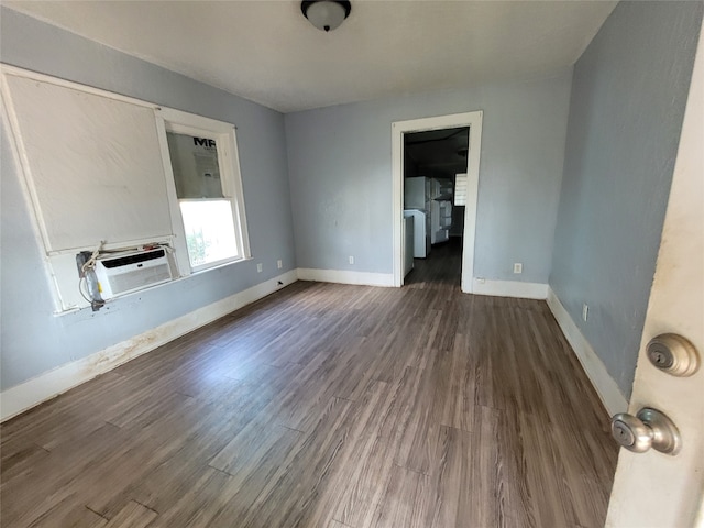 spare room with dark wood-type flooring