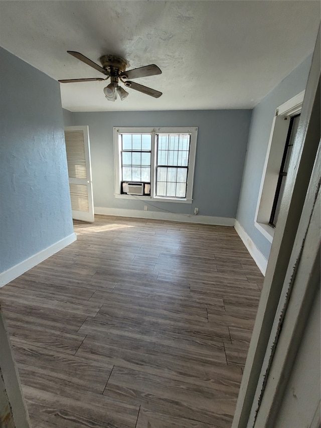 unfurnished room with dark hardwood / wood-style floors and ceiling fan