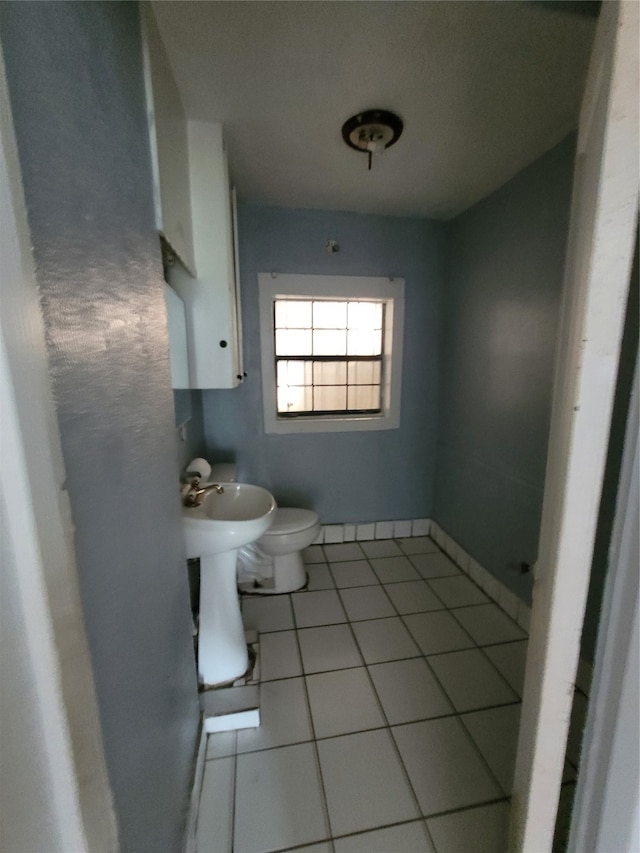 bathroom with sink, tile flooring, and toilet