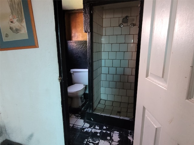 bathroom featuring toilet and tile flooring