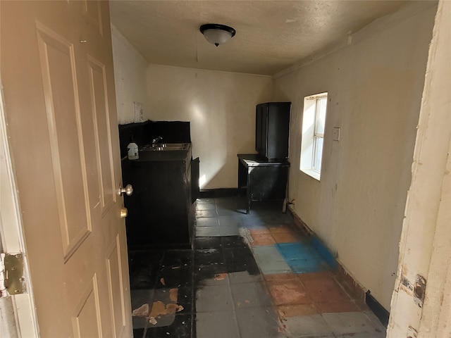 interior space with sink and dark tile flooring