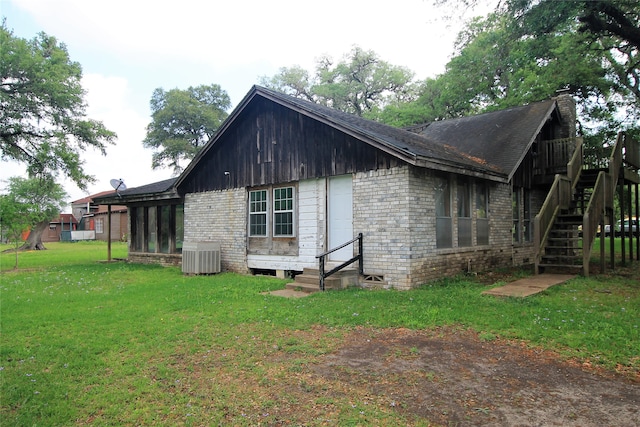 view of home's exterior featuring central air condition unit and a lawn