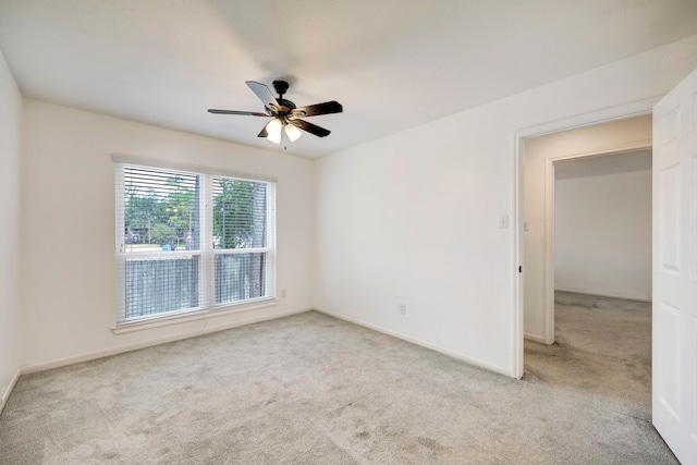 carpeted empty room with ceiling fan