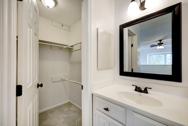 bathroom featuring ceiling fan and oversized vanity