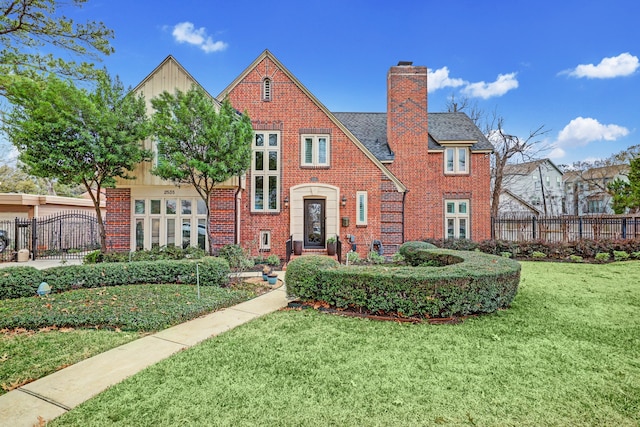 tudor home featuring a front yard