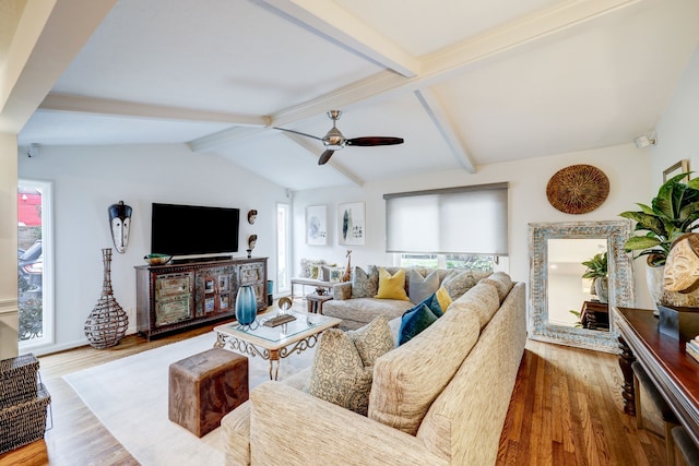 living room with hardwood / wood-style floors, vaulted ceiling with beams, and ceiling fan