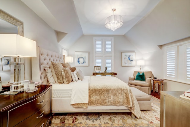 bedroom with vaulted ceiling and an inviting chandelier