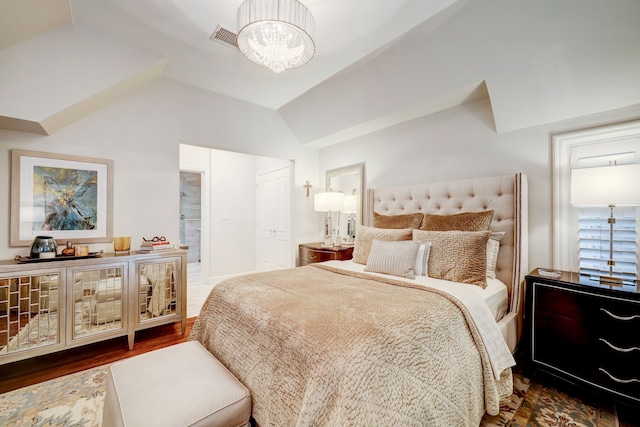 bedroom with lofted ceiling, dark wood-type flooring, and a chandelier