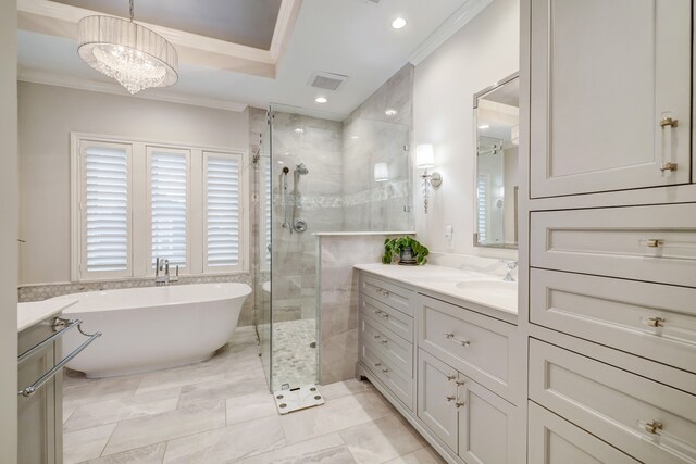 bathroom featuring crown molding, vanity, shower with separate bathtub, and an inviting chandelier