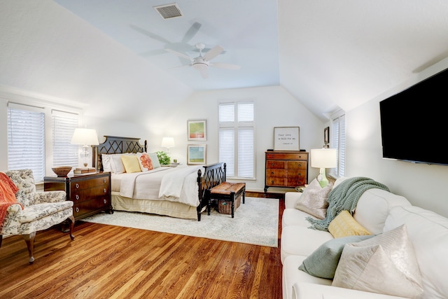 bedroom featuring hardwood / wood-style floors, vaulted ceiling, and ceiling fan